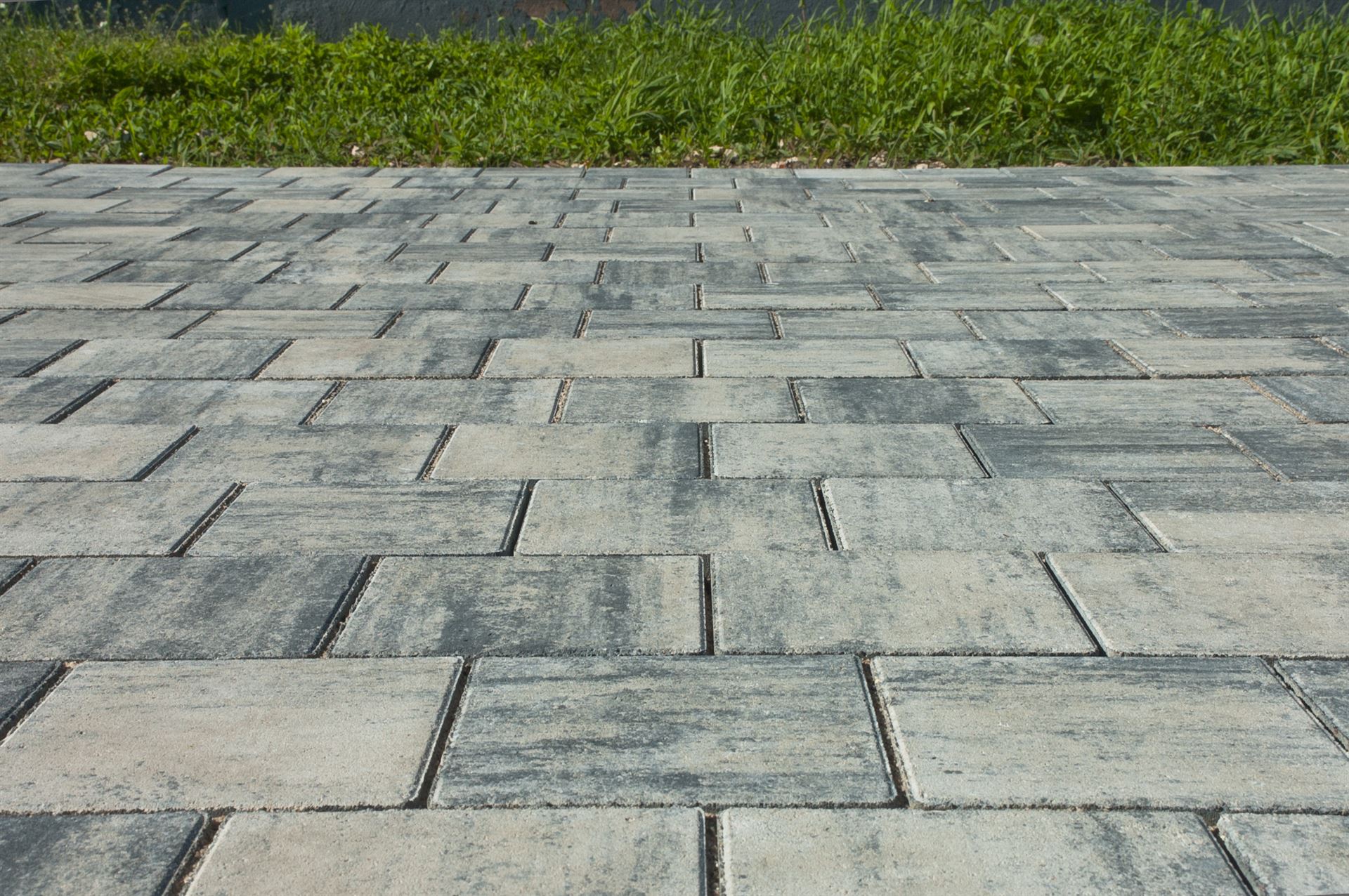 paving slabs, in the photo sidewalk decorative gray tiles close-up.